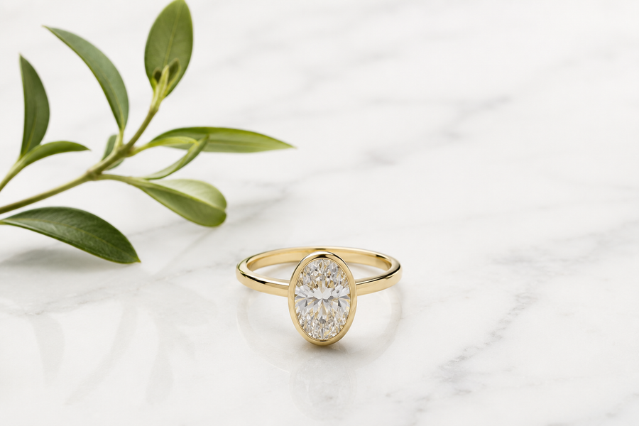 Clean editorial image of a lab-grown diamond ring with soft green botanical accents — Stella Fine Jewellery sustainability guide