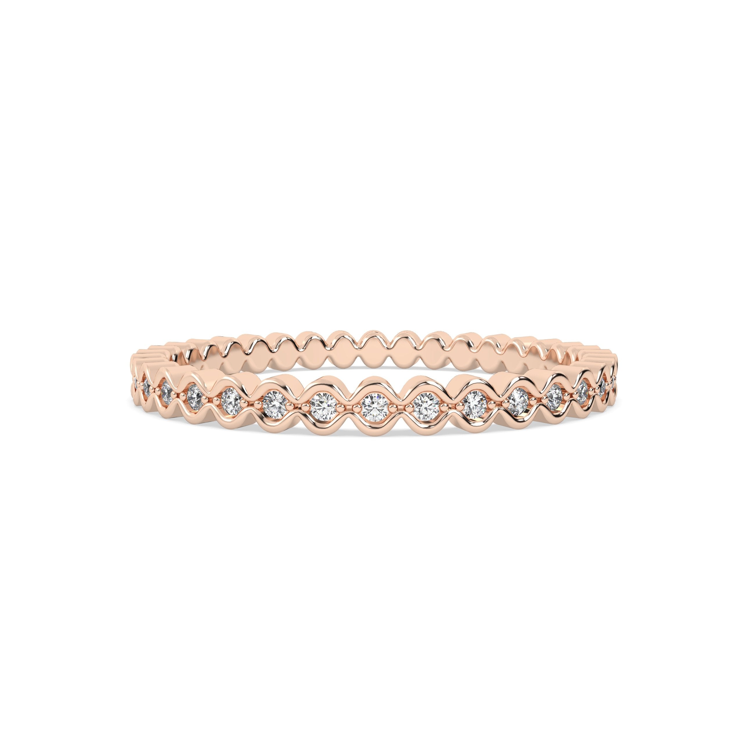 Gold ring with round diamonds on a pink background