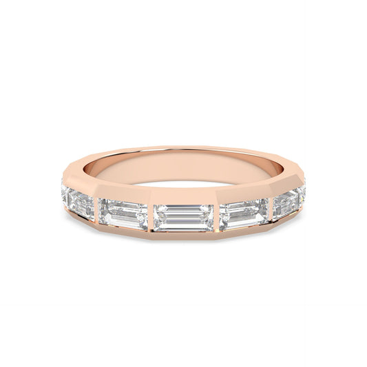 Rose gold ring with baguette cut diamonds on a gold background