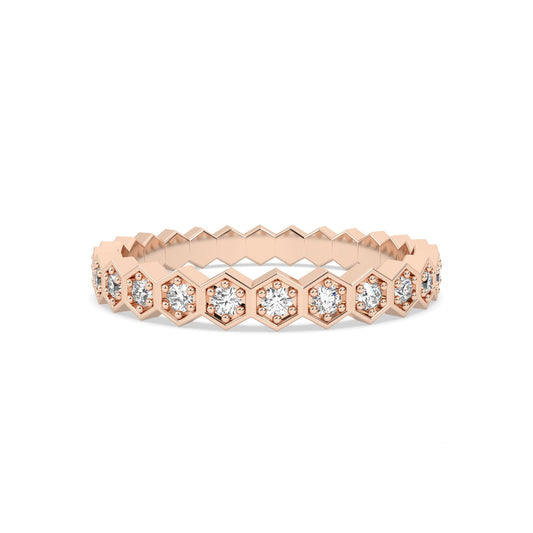 Rose gold ring with diamond accents on a gold background