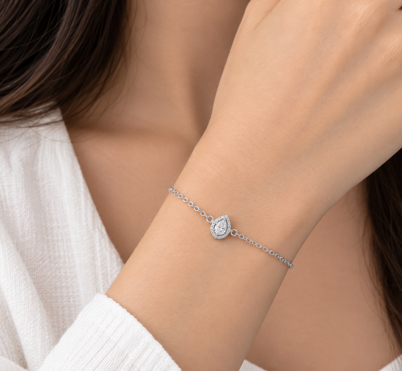 Pear halo lab grown diamond gold bracelet, worn on the wrist